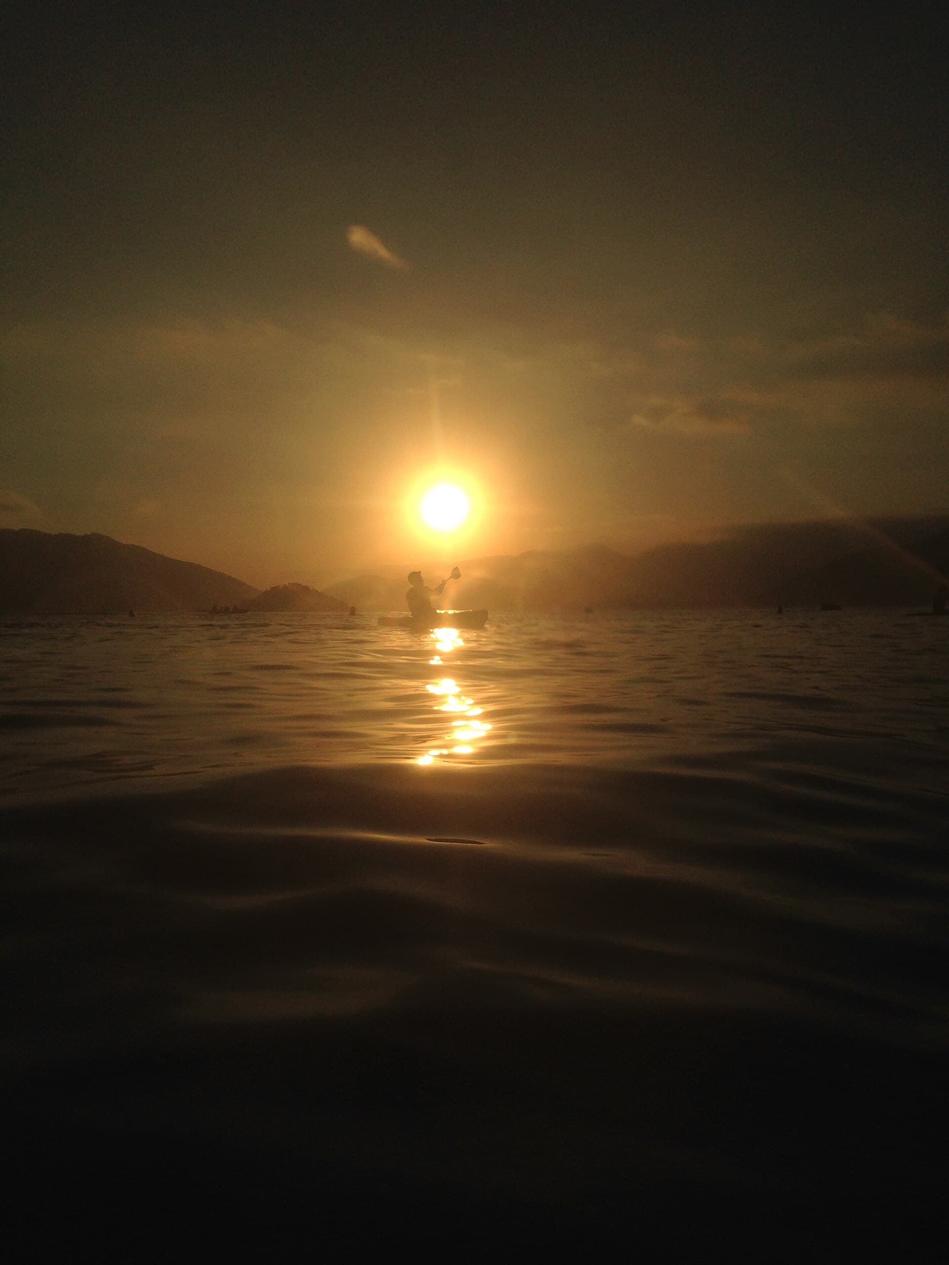 At the end of the day, the sun sets behind the Corcovado peak and paints Lagoinha gold.